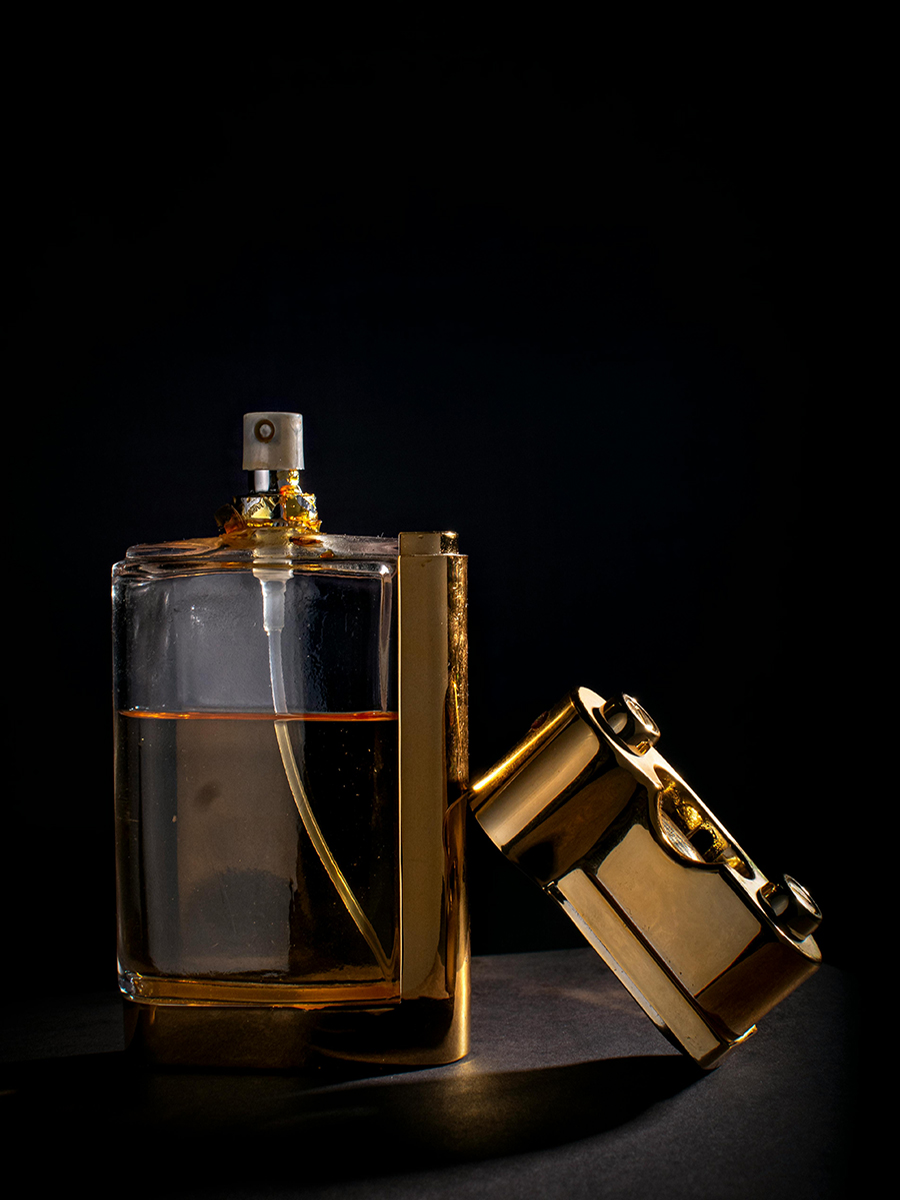 gold coloredperfume bottles on a dark background
